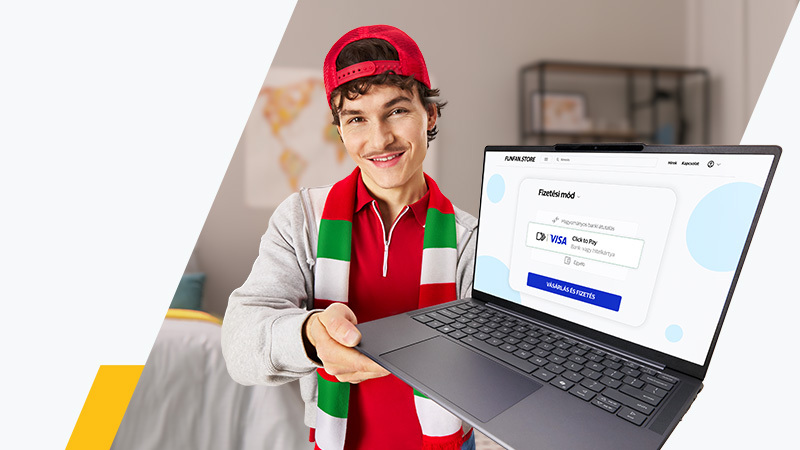 Man in red hat holding up a laptop